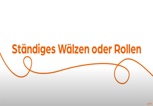 Text „Ständiges Wälzen oder Rollen“ mit orangefarbener Spirale auf weißem Hintergrund.