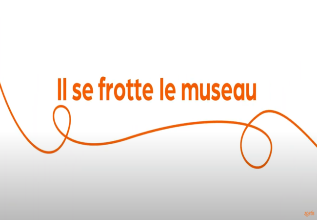 Texte « Il se frotte le museau » avec une spirale orange sur fond blanc.