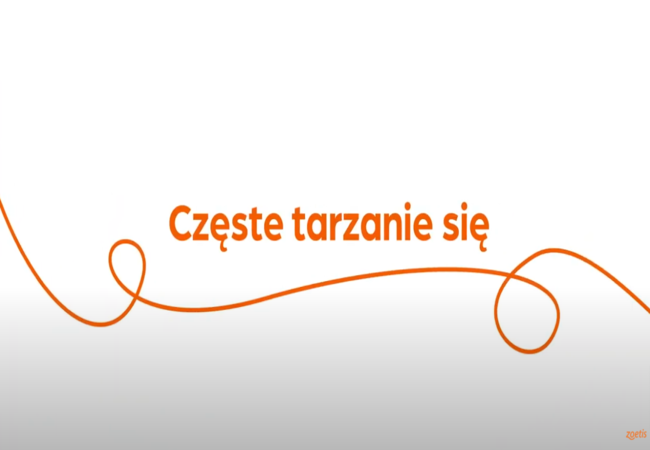 Tekst „Częste tarzanie się" z pomarańczową spiralą na białym tle.
